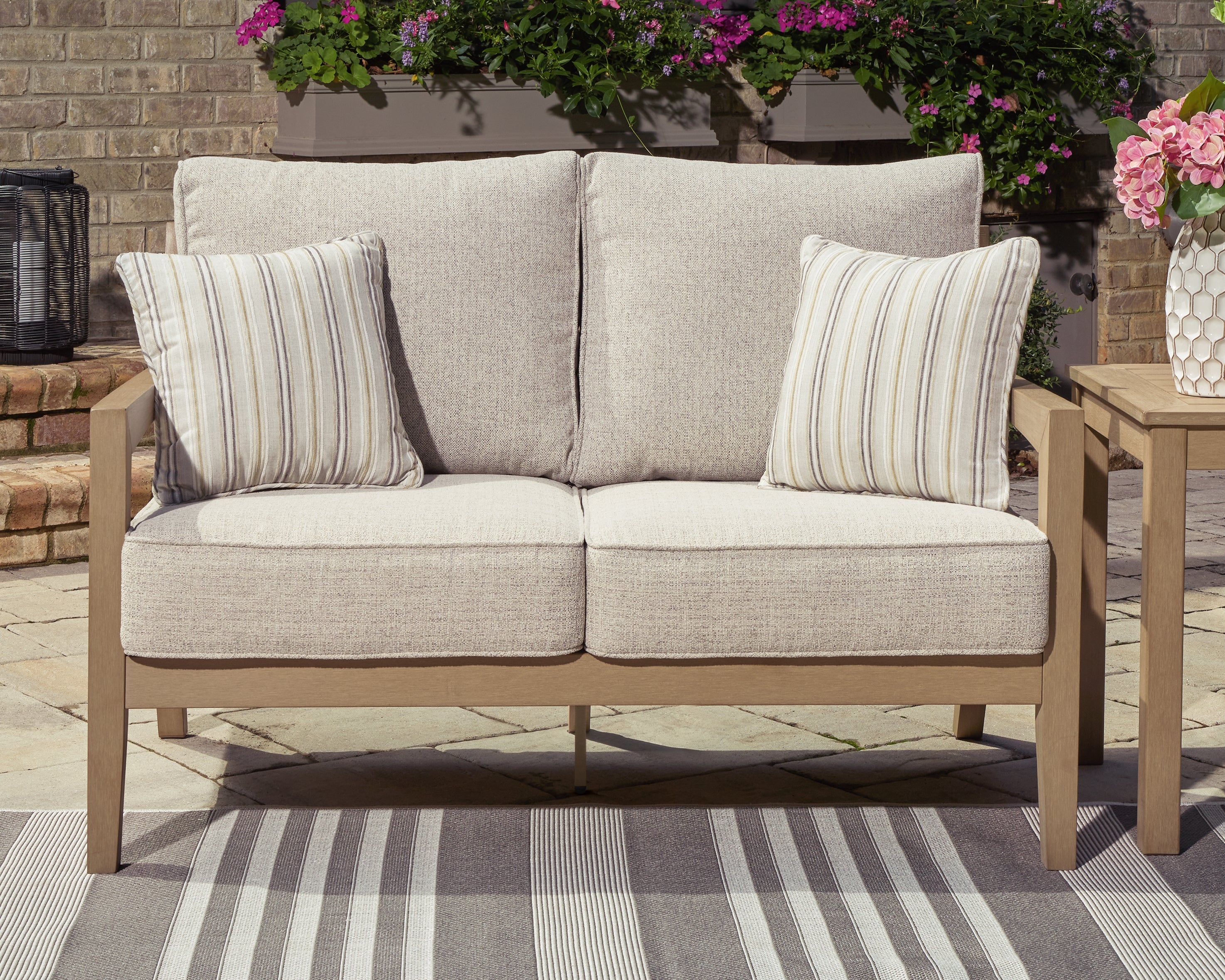 J&M Furniture - Ashley Furniture - Hallow Creek Outdoor Loveseat with Cushion - Loveseat w/Cushion - P560-835