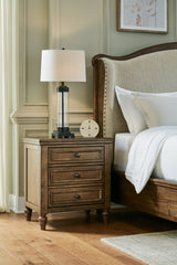 J&M Furniture - Ashley Furniture - Sturlayne Nightstand - Three Drawer Night Stand / Brown - B787-93