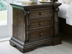 J&M Furniture - Ashley Furniture - Maylee Nightstand - Three Drawer Night Stand / Dark Brown - B947-93