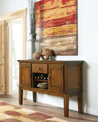 J&M Furniture - Ashley Furniture - Ralene Dining Server - Dining Room Server / Medium Brown - D594-60