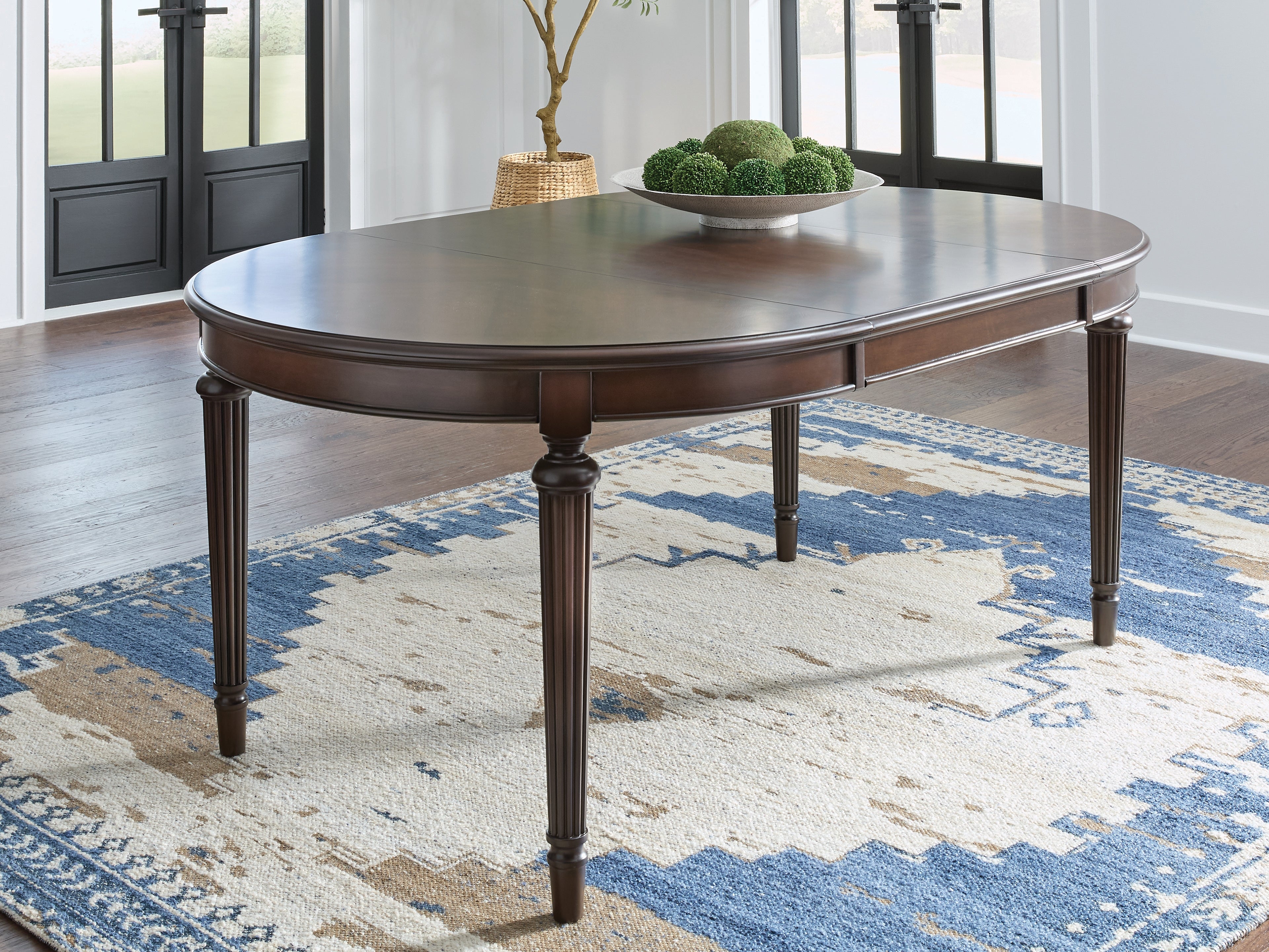 J&M Furniture - Ashley Furniture - Lavinton Dining Extension Table - Oval Dining Room EXT Table / Brown - D764-35