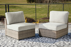 J&M Furniture - Ashley Furniture - Calworth Outdoor Armless Chair with Cushion (Set of 2) - Armless Chair w/Cushion (Set of 2) / Beige - P458-846