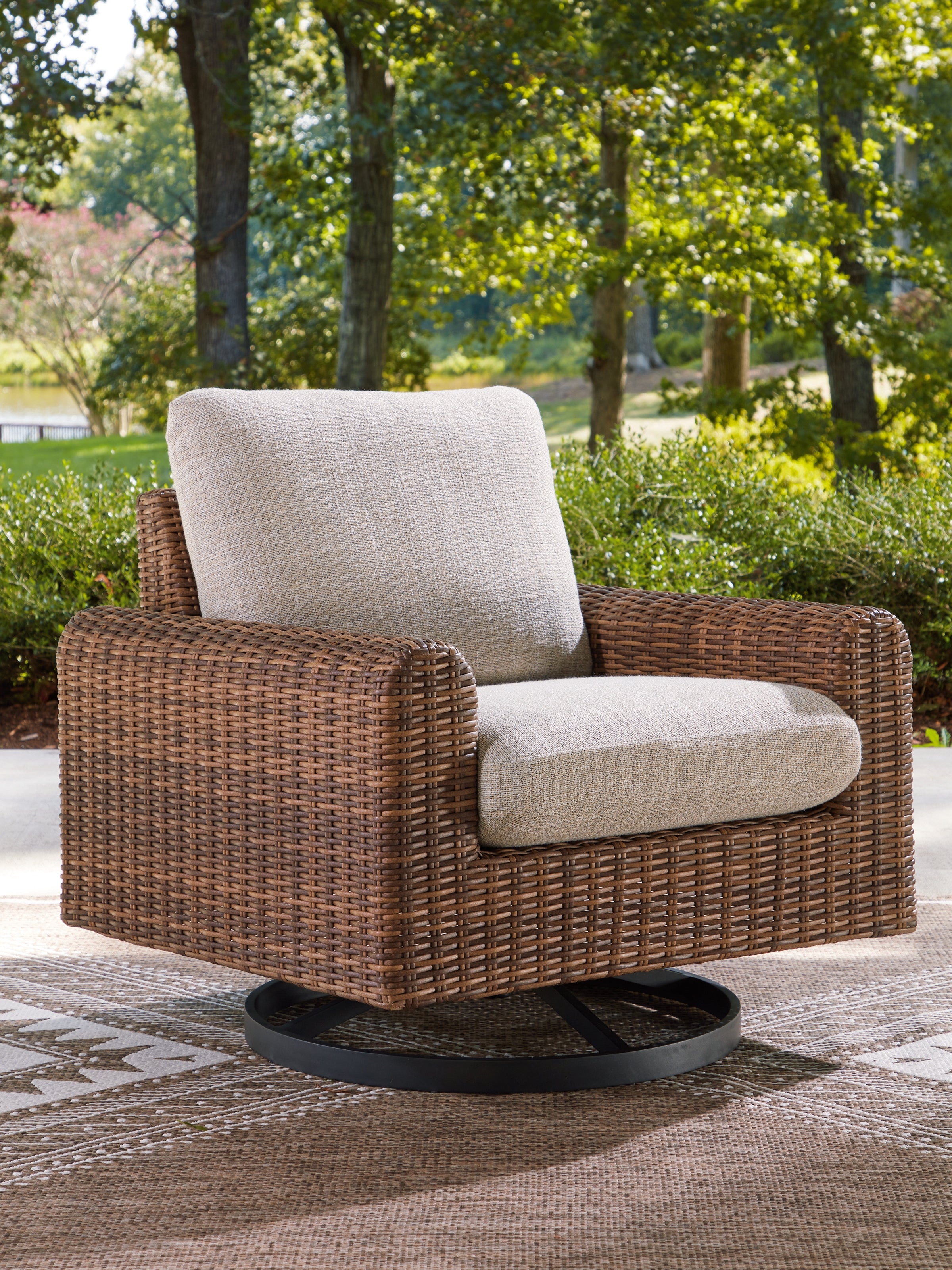J&M Furniture - Ashley Furniture - Dolan Creek Outdoor Swivel Lounge Chair with Cushion - Swivel Lounge w/ Cushion / Gray/Brown - PCP610-821