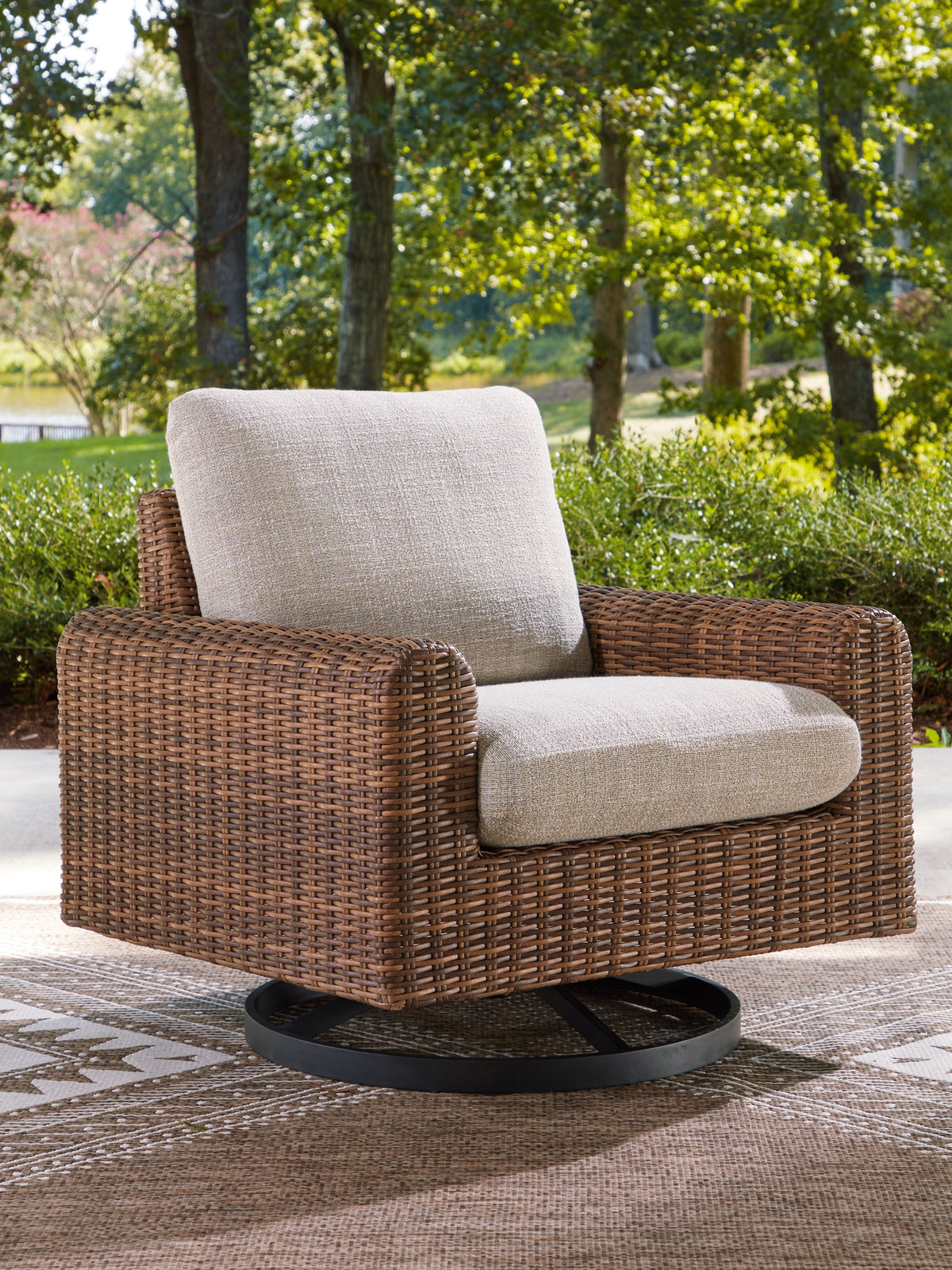 J&M Furniture - Ashley Furniture - Dolan Creek Outdoor Swivel Lounge Chair with Cushion - Swivel Lounge w/ Cushion / Gray/Brown - PCP610-821