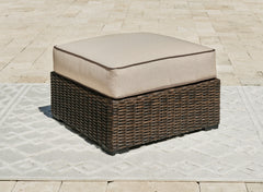 J&M Furniture - Ashley Furniture - Coastline Bay Outdoor Ottoman with Cushion - Ottoman with Cushion / Brown - P784-814