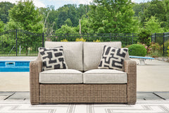 J&M Furniture - Ashley Furniture - Beachcroft Outdoor Loveseat with Cushion - Loveseat w/Cushion / Beige - P791-835