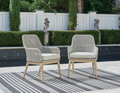 J&M Furniture - Ashley Furniture - Seton Creek Outdoor Dining Arm Chair (Set of 2) - Arm Chair With Cushion (Set of 2) / Gray - P798-601A