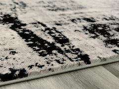 J&M Furniture - Ashley Furniture - Zekeman 5'3" x 7'7" Rug - 5'3" x 7'7" Rug / Black/Cream/Gray - R404922