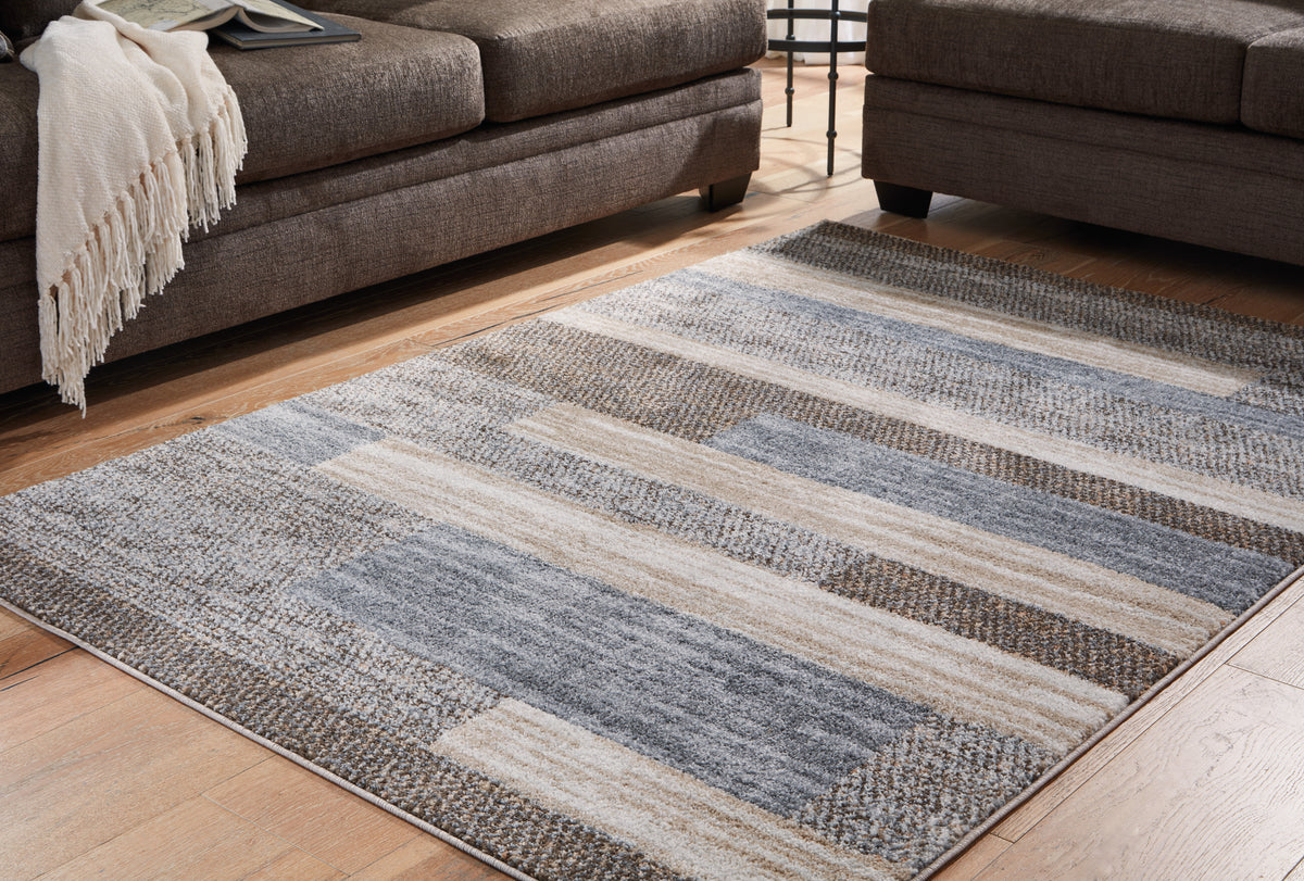 J&M Furniture - Ashley Furniture - Sethburn 5' x 7' Rug - 5' x 7' Rug / Cream/Brown/Gray - R406592