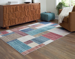 J&M Furniture - Ashley Furniture - Numore 5'2" x 6'11" Washable Rug - 5'2" x 6'11" Washable Rug / Multi - R406662