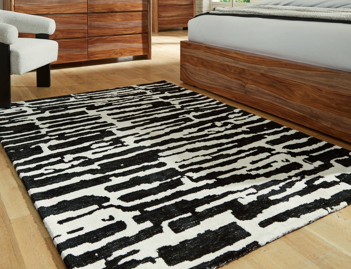 J&M Furniture - Ashley Furniture - Bramshaw 5' x 7' Rug - 5' x 7' Rug / Black/Ivory - R406762
