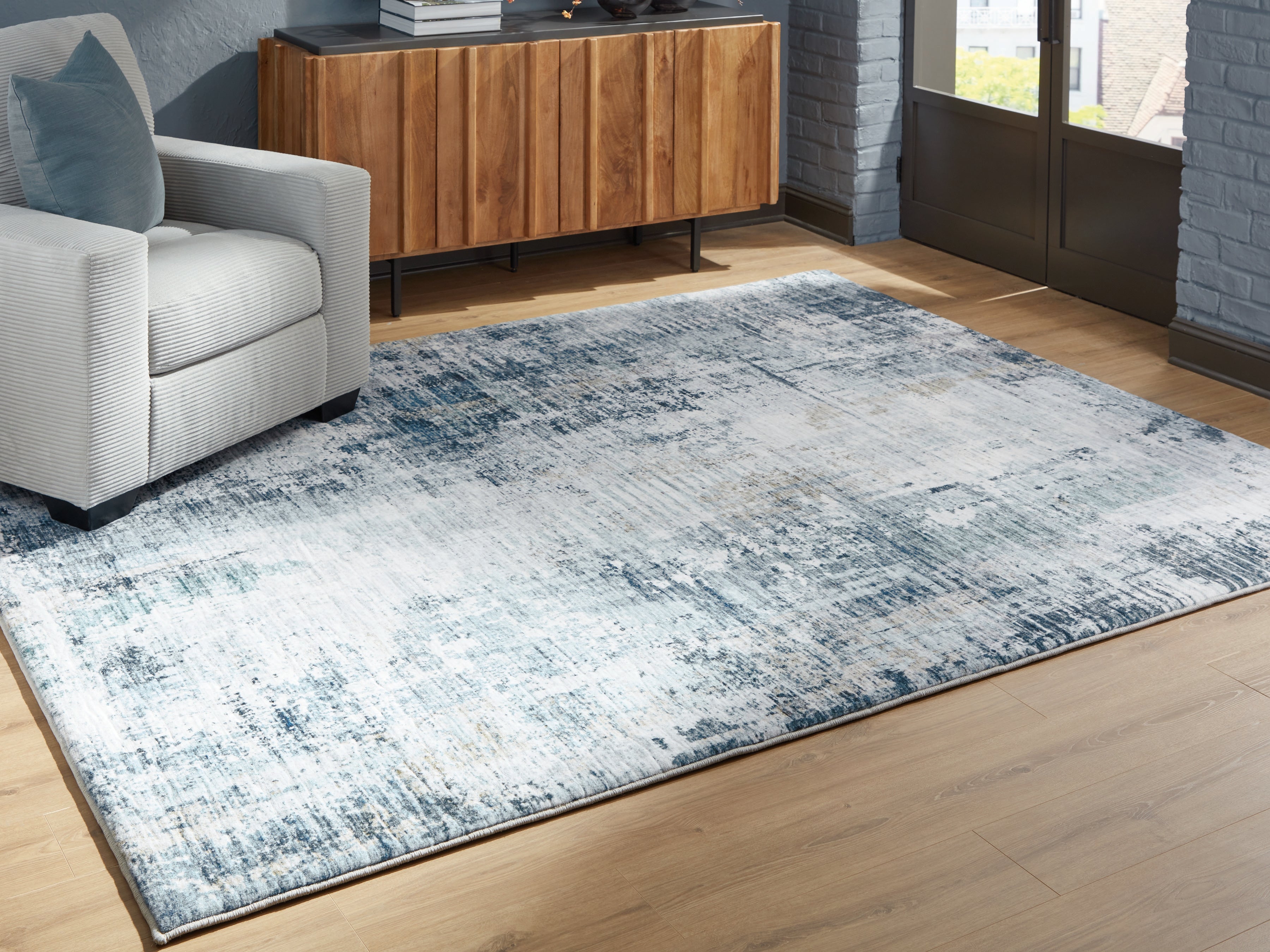 J&M Furniture - Ashley Furniture - Arlenmont 7'6" x 9'6" Area Rug - 7'6" x 9'6" Area Rug / Blue/White/Brown - R407481