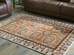 J&M Furniture - Ashley Furniture - Qaabiz 5' x 7' Area Rug - 5' x 7' Area Rug / Sienna/Ivory/Black - R407522