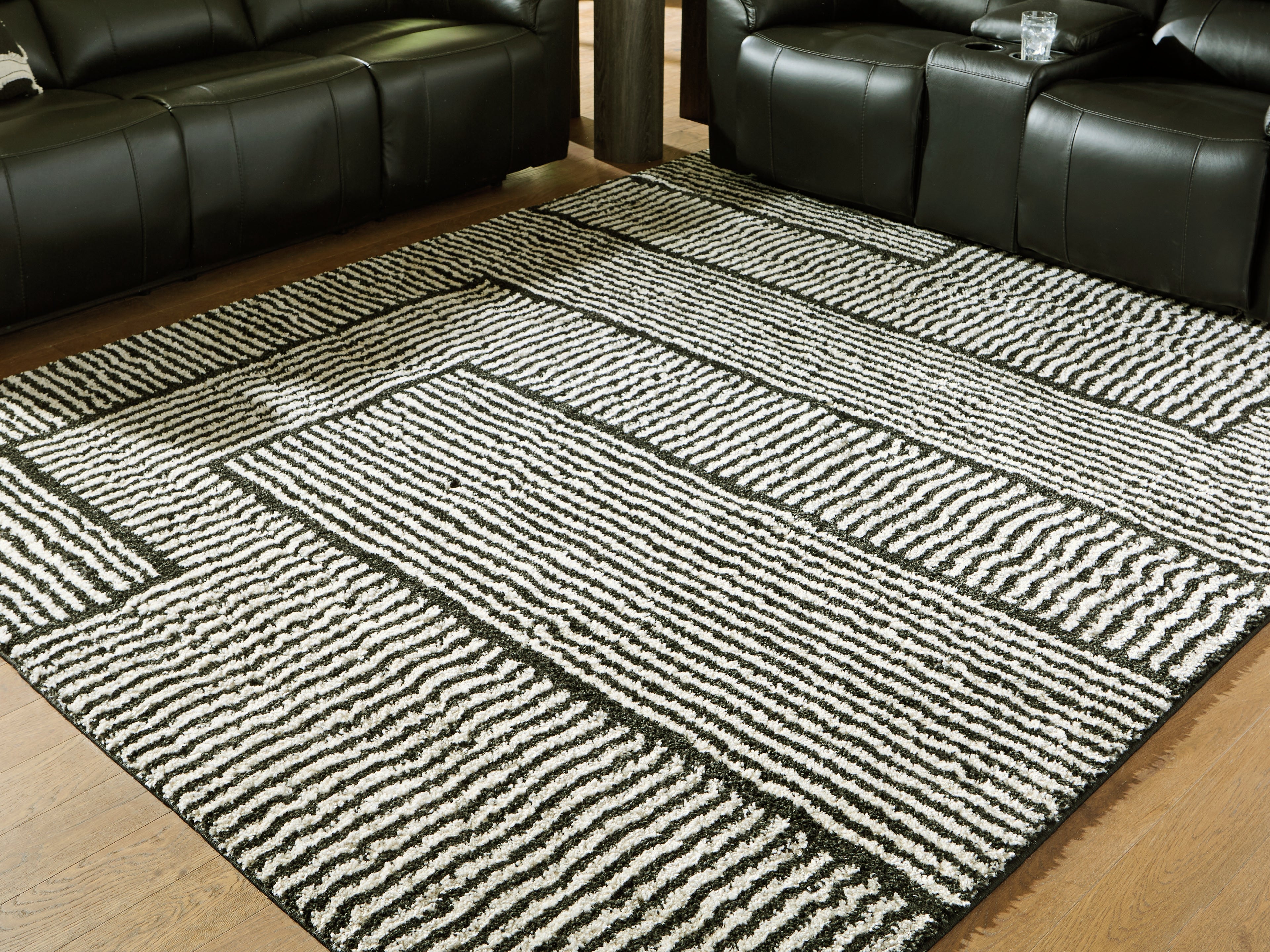 J&M Furniture - Ashley Furniture - Kurtmen 7'10" x 9'10" Area Rug - 7'10" x 9'10" Area Rug / Black/Ivory - R407591
