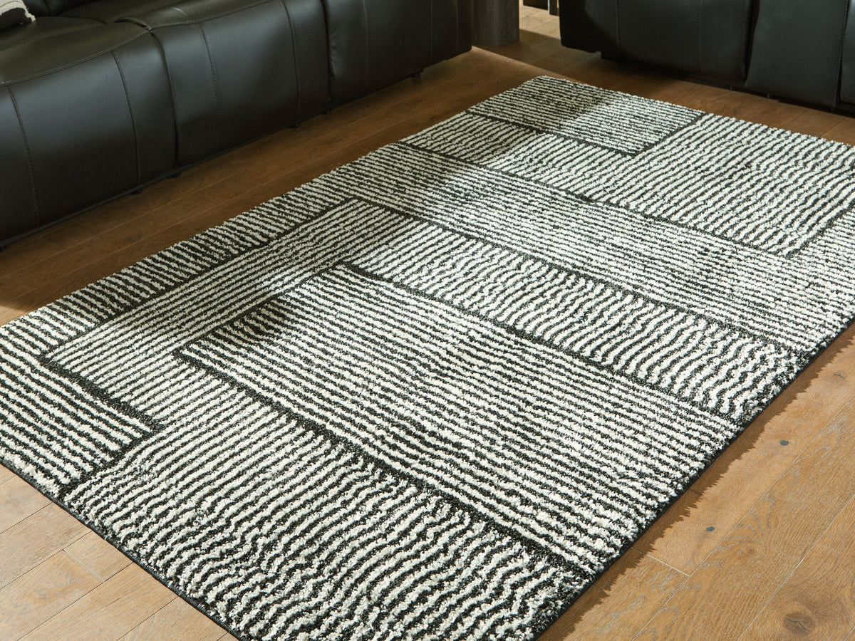 J&M Furniture - Ashley Furniture - Kurtmen 5' x 7' Area Rug - 5' x 7' Area Rug / Black/Ivory - R407592