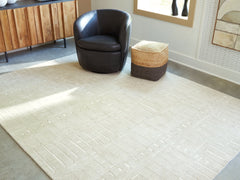 J&M Furniture - Ashley Furniture - Wolbert 7'8" x 10' Area Rug - 7'8" x 10' Area Rug / Tan/Ivory - R407661