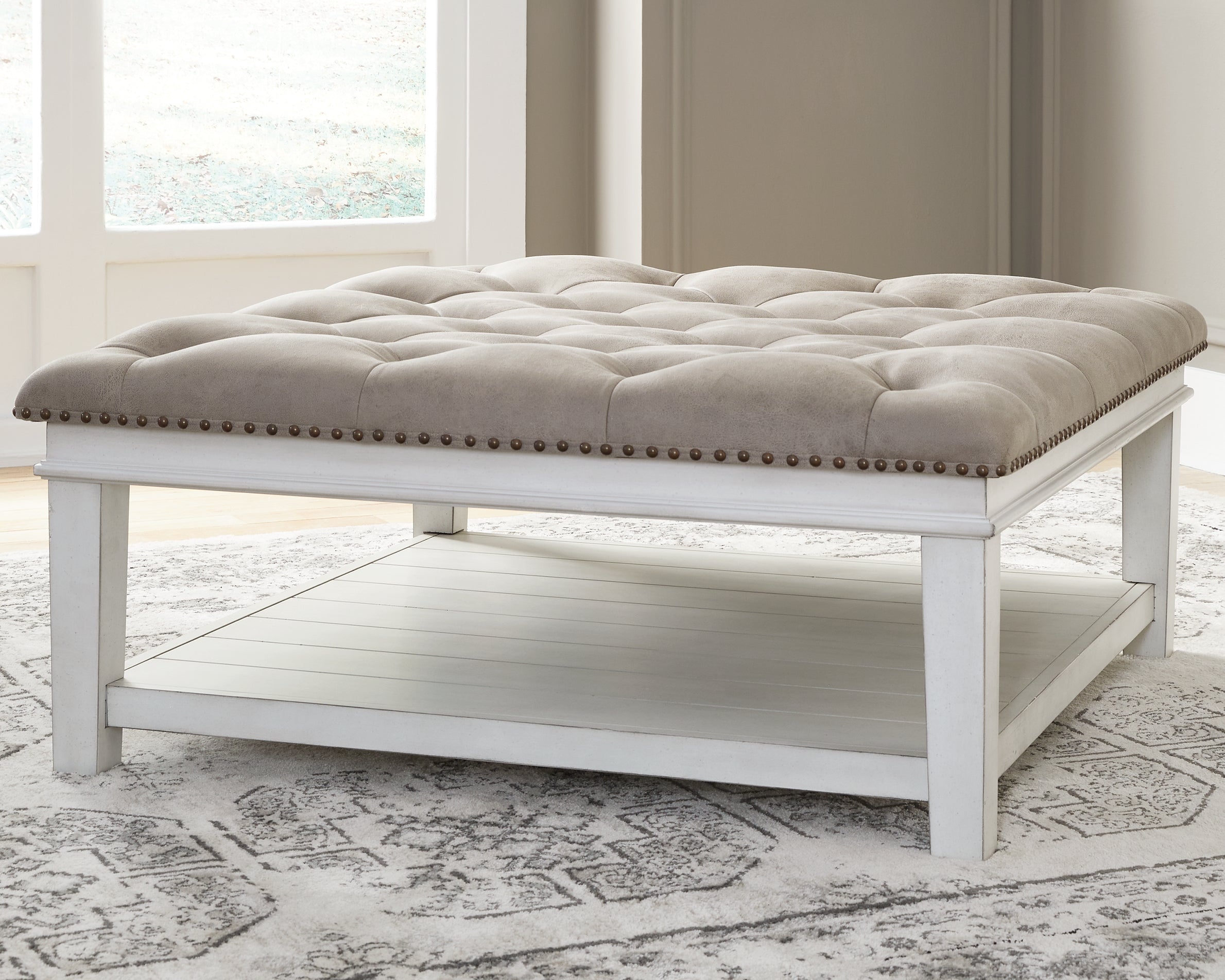 J&M Furniture - Ashley Furniture - Kanwyn Upholstered Ottoman Coffee Table - UPH Ottoman Cocktail Table / Whitewash - T937-21