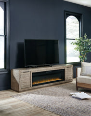 J&M Furniture - Ashley Furniture - Krystanza TV Stand with Electric Fireplace - TV Stand with Electric Fireplace / Weathered Gray - W760W1